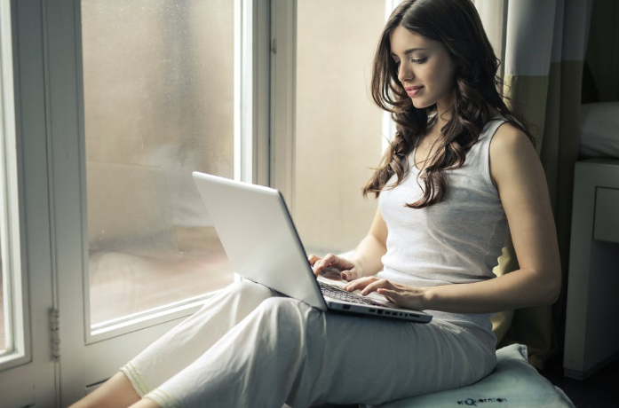 a woman sitting by the window